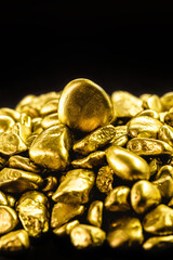 Sticker - many gold nuggets on isolated black background, concept of wealth and rare ores