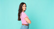 © kues1 - young pretty woman smiling to camera with crossed arms and a happy, confident, satisfied expression, lateral view