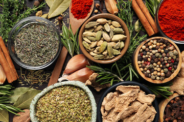 Different natural spices and herbs on table, flat lay