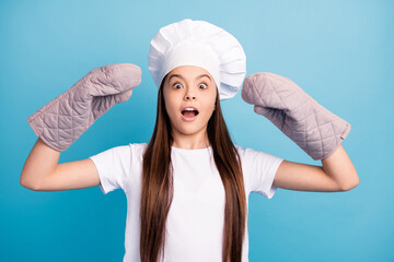 Sticker - Photo of cheerful amazed shocked little girl wear gloves hat cook dinner isolated on pastel blue color background