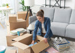 © StockPhotoPro - Woman unpacking in her new apartment