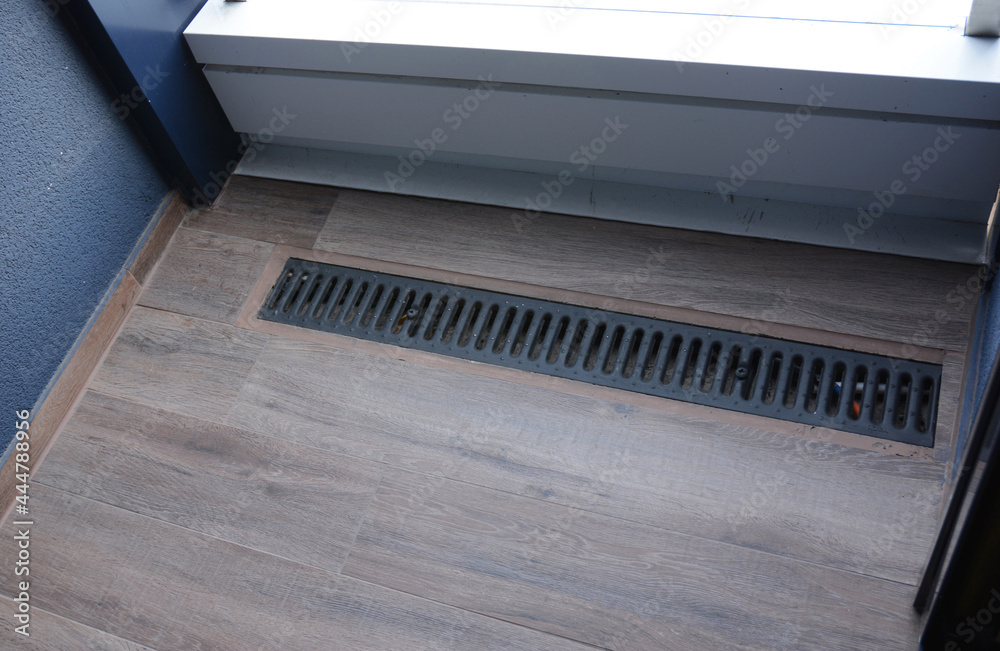 Balcony drainage or gutter. A close-up of a balcony floor drainage system with a self regulating heating, deicing cable installed.