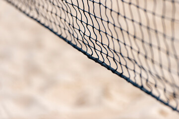 Wall Mural - Beach volleyball and beach tennis net on the background of sand. Summer sport concept