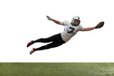 Fototapeta Sport - Portrait of American football player catching ball in jump isolated on white studio background.