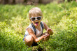 © Tomsickova - Toddler blond child, eating wild blueberries in forest