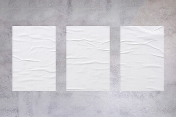 Blank white wheatpaste glued paper poster mockup on concrete wall background