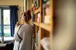 © Martin Barraud/Caia Image - Woman with headphones and coffee in home office