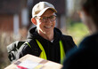 © Martin Barraud/Caia Image - Friendly male courier delivering package