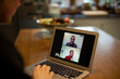 © Martin Barraud/Caia Image - Colleagues video chatting on laptop