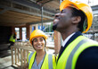 © Paul Bradbury/Caia Image - Happy construction workers talking at construction site