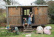 © Sam Edwards/Caia Image - Portrait young couple in tiny cabin rental doorway