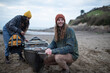 © Sam Edwards/Caia Image - Smiling young couple with canoe on beach