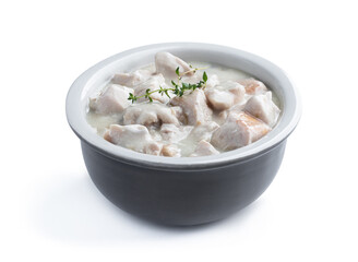 Chicken breast in creamy garlic sauce in ceramic bowl isolated on white