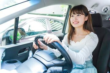 Wall Mural - Young woman driving a car