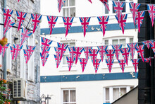 British Union Jack Flag Triangular Hanging In Preparation For A Street Party. Festive Decorations Of Union Jack Bunting.