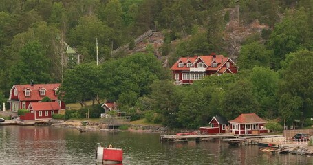 Wall Mural - Swedish Wooden Sauna Log Cabin House On Island Coast In Summer Cloudy Day