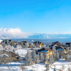 Square Panorama of snowy mountain town and valley on a scenic sunny winter setting