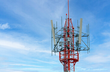 Telecommunication tower with blue sky and white clouds background. Antenna on blue sky. Radio and satellite pole. Communication technology. Telecommunication industry. Mobile or telecom 4g network.