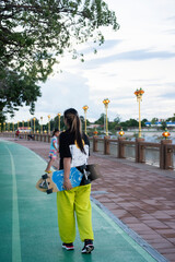 Asian women leg on surf skate or skate board