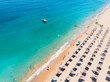 Golden Sands beach from above. A summer drone shot over the beach with crystal clear seawater in Bulgaria. People playing on the beach and a boat nearby.