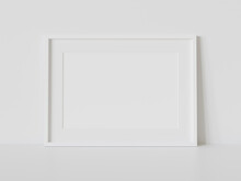 White Frame Leaning On White Floor In Interior Mockup. Template Of A Picture Framed On A Wall 3D Rendering