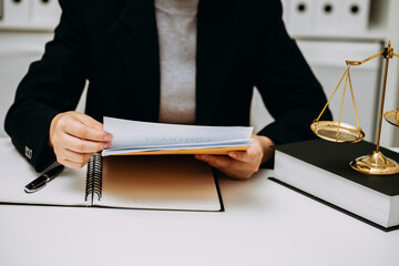 The female lawyer working and reading contract draft in the office room at the law firm, legal advisor and justice concept.