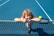 © Volodymyr - Little boy playing tennis. Sport kids, thumbs up, winner. Child with tennis racket on tennis court. Training for young kid, healthy children.