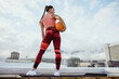 © Jacob Lund - Athlete woman with basketball on rooftop