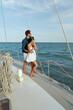 © Drobot Dean - Young couple rest on yacht boat and looking at sea