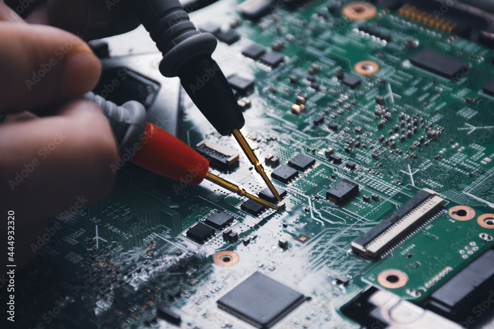 Technician checking laptop circuit board with multimeter Stock Photo ...