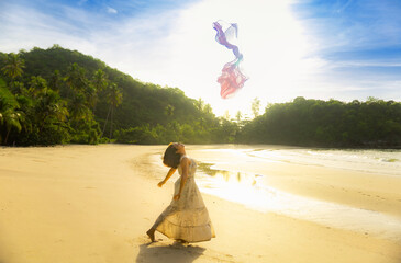 A woman is feeling happy on a beautiful beach.