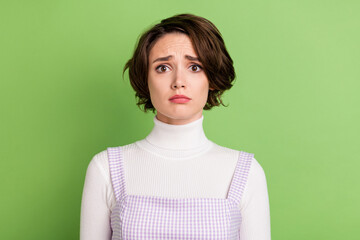 Photo of young woman unhappy sad upset negative moody sorrow fail isolated over green color background