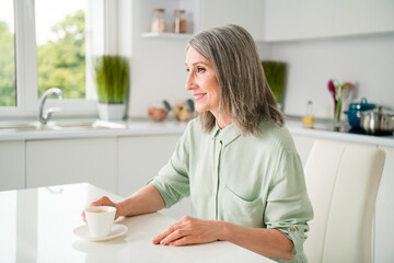 Sticker - Profile side view portrait of attractive cheerful grey-haired woman drinking espresso staying at home light white indoors