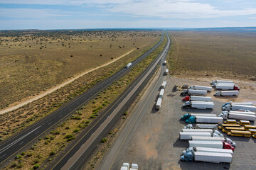 Wall Mural - Aerial view of highway rest area with large car park for cars trucks top view of highway in desert Arizona