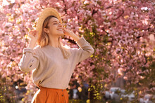 Young Woman Wearing Stylish Outfit In Park On Spring Day. Fashionable Look