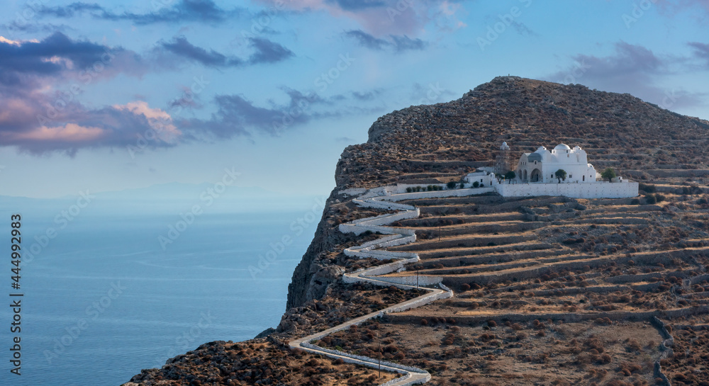 Folegandros island, Greece, Cyclades. Panagia Virgin Mary Church and long zigzag road.. - obrazy, fototapety, plakaty 