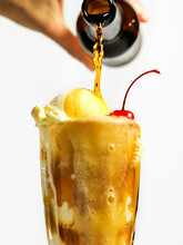 Pouring Root Beer Into A Float With Vanilla Ice Cream And Cherry.