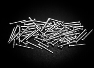 Sticker - Close up of a new collection of iron nails on a black isolated background