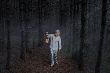 A vitiligo man with a kerosene lamp in the dark forest