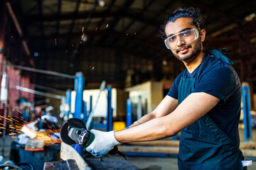 latin hispanic auto mechanic in uniform is examining a car while working in auto service