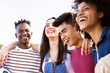 © Xavier Lorenzo - United multiethnic friends laughing and having fun together outdoors - Young adult group of funny people celebrating and hanging out - Summer holidays and college students concept - Focus on african
