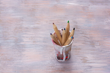 Wall Mural - Cup with pencils on a wooden table