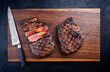 Modern style barbecue dry aged wagyu rib-eye beef steaks served as top view on a wooden design board with copy space