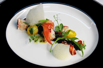 poached canadian lobster salad with cherry tomatoes and green leaves