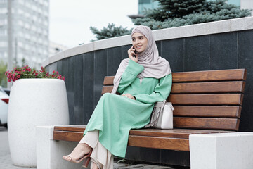 Wall Mural - Stylish Muslim Businesswoman on Bench