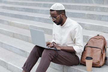 Poster - Concentrated Black Muslim Man Using Laptop