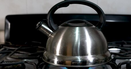 Wall Mural - A silver metal kettle on a gas stove in the kitchen
