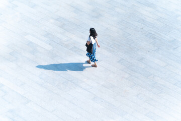 top aerial view people walk on across pedestrian concrete with black silhouette shadow on ground, concept of social still life...