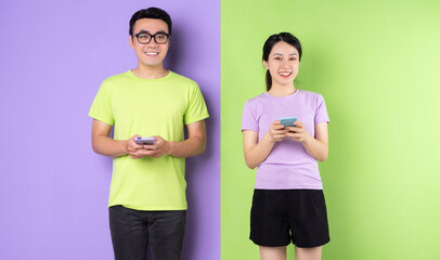 Wall Mural - Young Asian couple using smartphone, long distance love concept