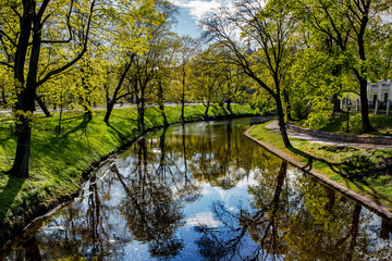  Riga river canal that flows through Bastion park Bastejkalns in springtime, Riga, capital of Latvia.
